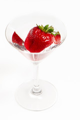 strawberries in glass on white background