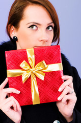 Young woman with red gift box