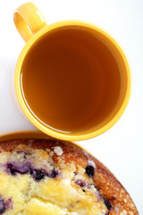 View from above of blueberry cake and a cup of green tea