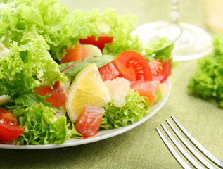 Fresh salad with tomatoes, lemon and salmon