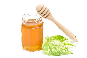 jar of honey and wooden drizzler