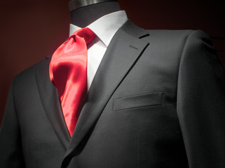 Dark grey jacket with white shirt and red tie