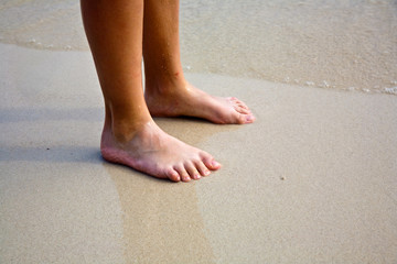 feet on the beautiful sandy beach