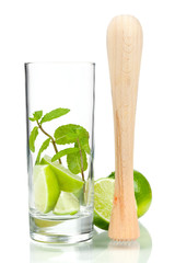 Mojito mix: lime, mint in glass and muddler