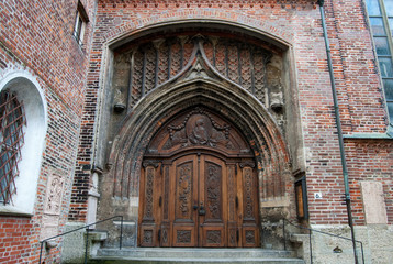 Ornate wooden dor th the church in Munich, Bavaria, Germany