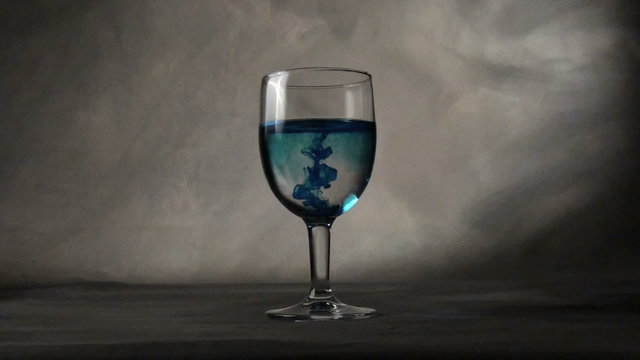 ink in a glass on background