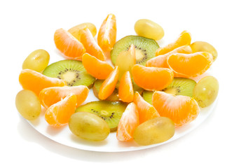 Tangerune and kiwi on plate isolated