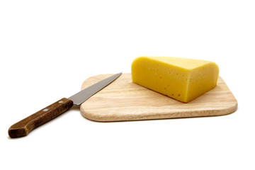 Cheese and Knife on a Cutting Board
