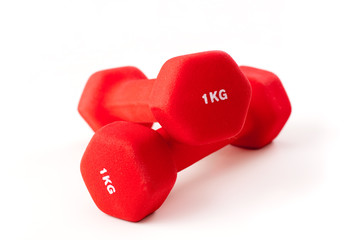 Two red dumbbells on white background