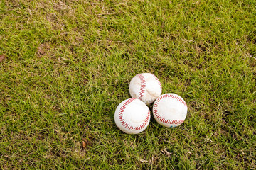Grass and Three Baseballs