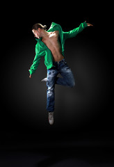modern dancer poses in front of the old dirty wall.