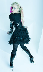 woman with dreadlocks wearing extravagant clothes and boots