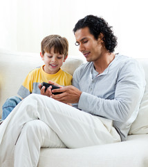 Caring father and his son sitting on a sofa