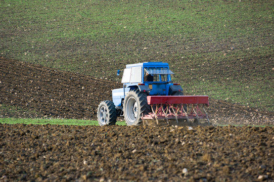 tractor is plowing the field