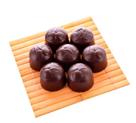 Chocolates on wooden surface isolated