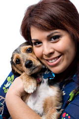 Woman Cuddling a Puppy