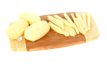 sliced raw potatoes on a chopping board isolated on white
