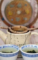 Obraz na płótnie Canvas Green tea with cup and teapot