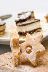 homemade sweets in shape of a star with bar cookies in the backg