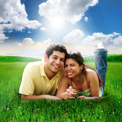 Happy Couple Laying Down in a Green Field