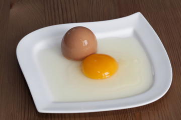 broken egg on white plate