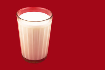 Glass with milk on the red