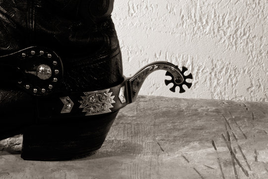 Cowboy boots with spurs on the wooden desk