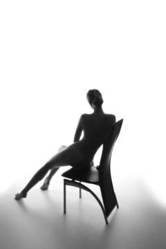 Silhouette of a beautiful young woman sitting