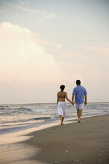Fototapeta na wymiar Couple Walking on Beach