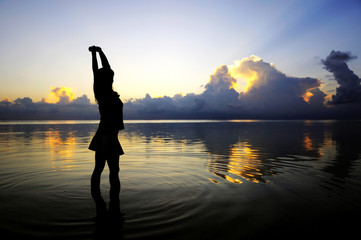 Fototapeta premium lady figure with sunset background at Maldives.