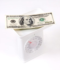 money on the kitchen weighing scale