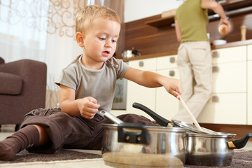 Little boy playing in kitchen