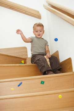 Little boy playing on stairs