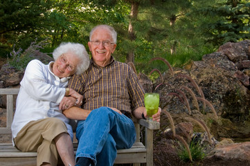 Elderly man and woman sitting on a bench