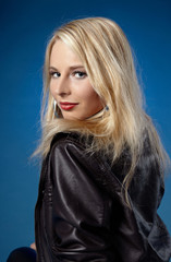 portrait of young pretty blonde on the blue background