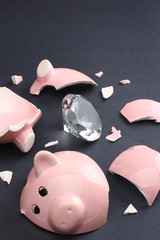 Broken piggy bank containing a diamond