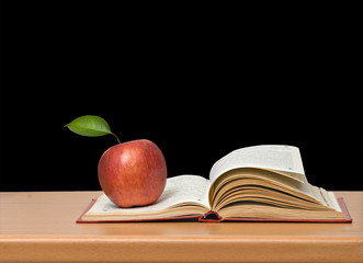 Red apple and book on desk