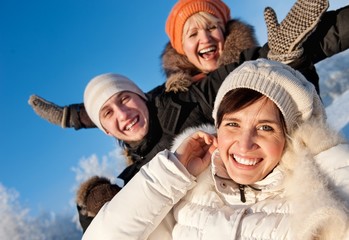 Happy friends on a winter background