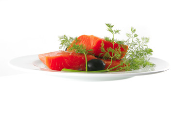 pink salmon on white plate with olives
