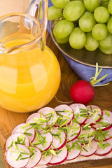 Radieschen auf Brot mit Weintrauben und Saft
