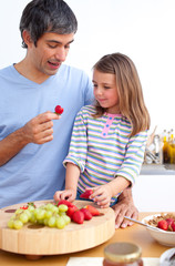 Cheerful father and his daughter having breakfast