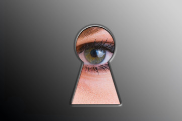 Woman looks through a keyhole