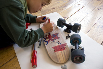 Child customizing his skateboard