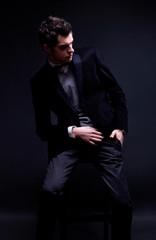 fashion shot of an elegant young man wearing suit