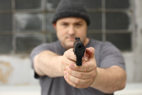 Portly robber with a gun.