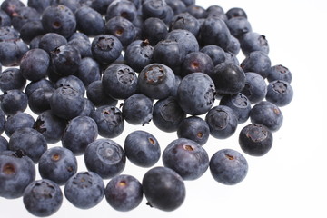 Pile of fresh blueberries isolated on white.