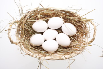 Basket of eggs on a glass table.