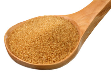 Brown sugar in a wooden spoon on a white background