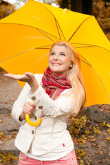 Young pretty woman with umbrella under the rain