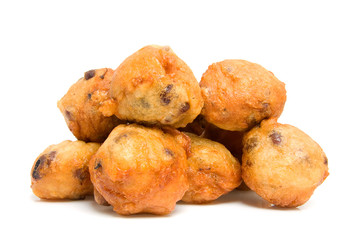 Pile of Dutch donut also known as oliebollen over white